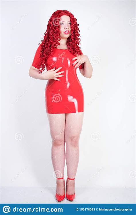 Real Doll Woman Wearing Red Latex Rubber Dress And Posing