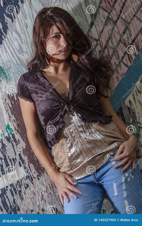 A Lovely Brunette Model Posing Outdoors With The Latest Fashions Stock