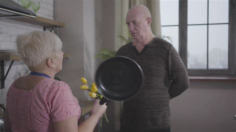 grandma threatens grandpa with frying pan free stock
