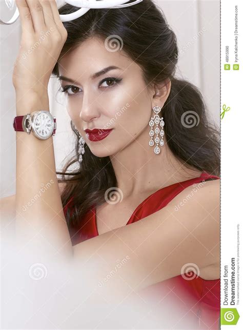 beautiful woman brunette brown eyes in a red dress in