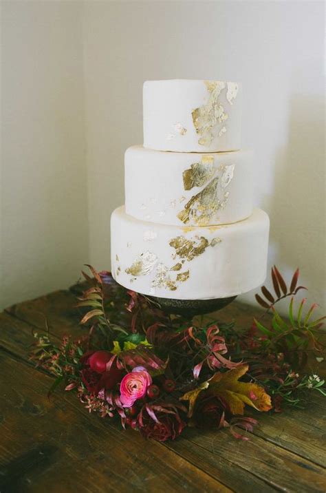 picture of gold leaf white wedding cake looks simple