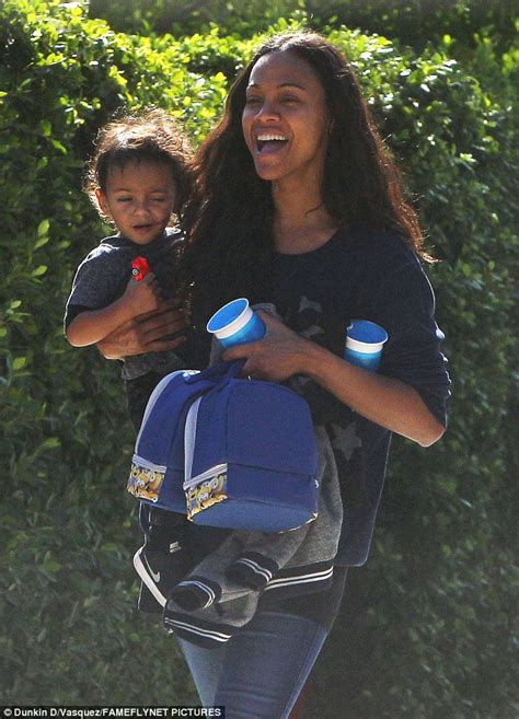 zoe saldana looks thrilled during rare outing with twins and husband in