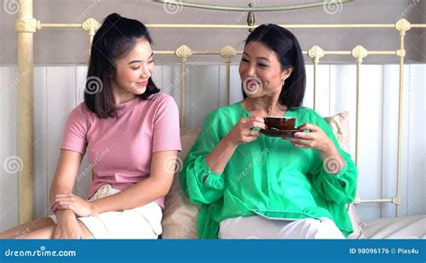 Asian Beautiful Mother And Pretty Teenage Daughter With Tablet Stock
