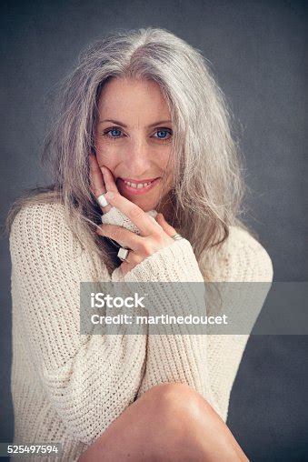 aging gracefully beautiful mature woman with silver hair portrait stock