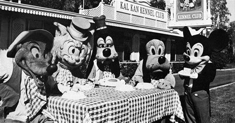 mickey mouse offers a piece of his cheese to his pals but they prefer the kennel club menu