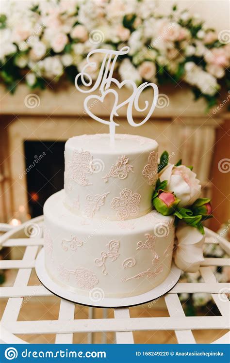 Elegant Simple Wedding Cake With An Ornate Topper Stock