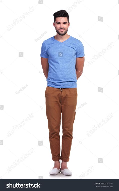young casual man standing straight  hands     white