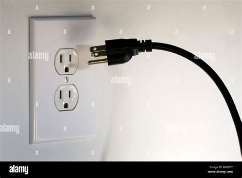 american  pronged plug hovering  front    volt ac electrical outlet stock photo