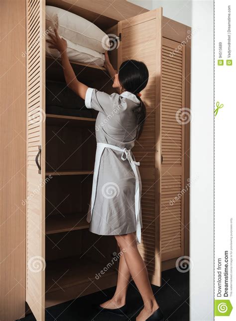 Hotel Maid Putting Bed Pillows In A Closet Stock Image