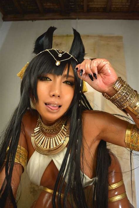 A Woman Dressed As An Egyptian Queen With Long Black Hair And Gold