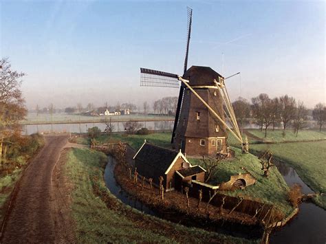 Old Dutch Windmill Near Amsterdam Photograph By Photo By
