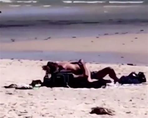 shocking moment randy couple are caught having sex in broad daylight on packed beach