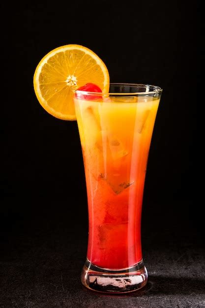 Premium Photo Tequila Sunrise Cocktail In Glass On Black