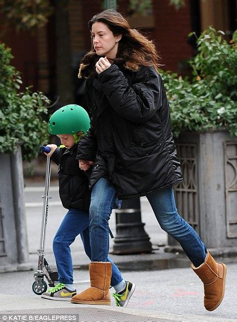 buckle up safety conscious liv tyler outfits son in protective gear for scooter ride daily