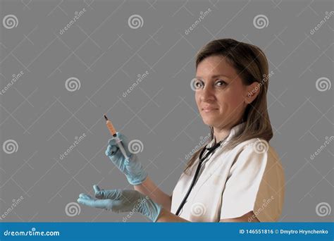 Female Doctor Or Nurse Holds In Hand A Syringe With Medicine Woman