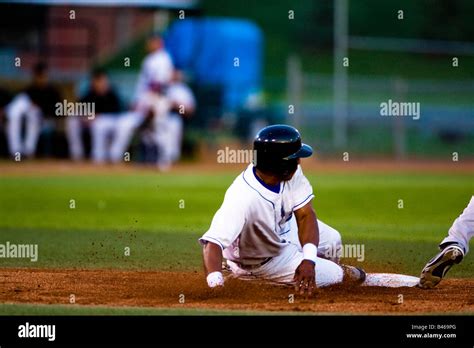 baseball player sliding   base stock photo alamy