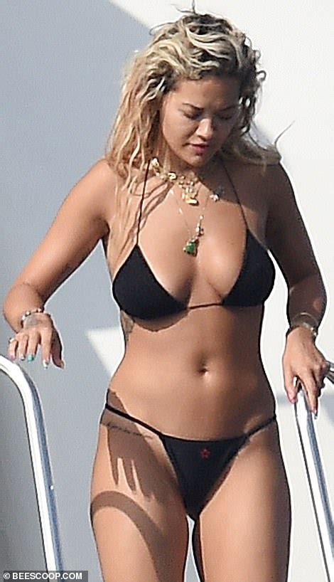 rita ora displays her curves in a skimpy black bikini as