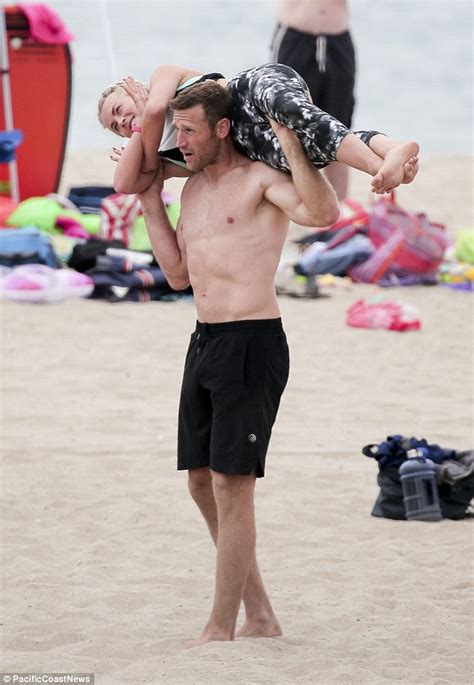 julianne hough s fiancé brooks laich puts her over his head while at the beach daily mail online