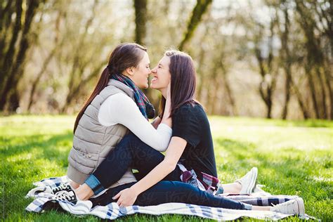 View Lesbian Couple Embracing On A Blanket In The Park By Stocksy