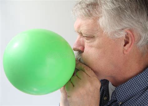senior man blowing  balloon stock image image  hand face