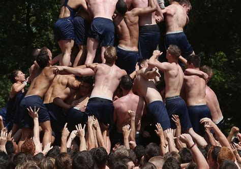 here s a bunch of hot shirtless navy freshmen climbing a greasy pole