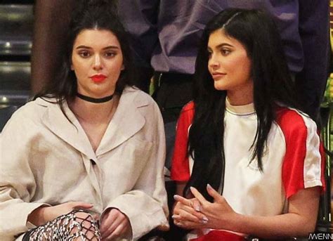 kendall jenner flashes bra during casual stroll while kylie flaunts