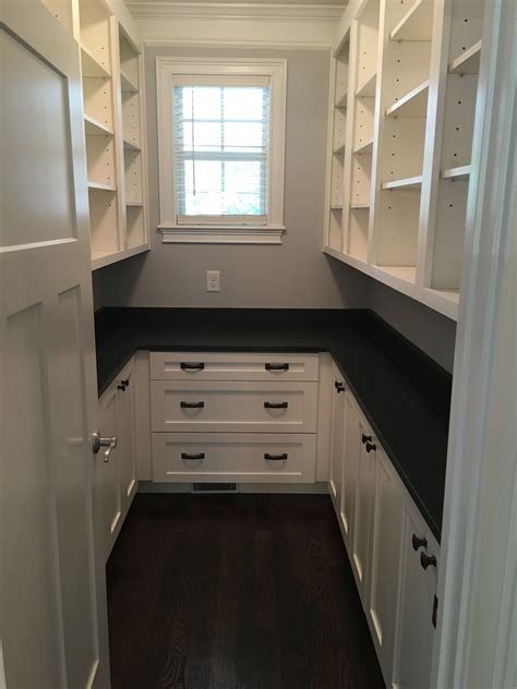 large walk  pantry  white shaker cabinets  honed dark granite pantry laundry room walk