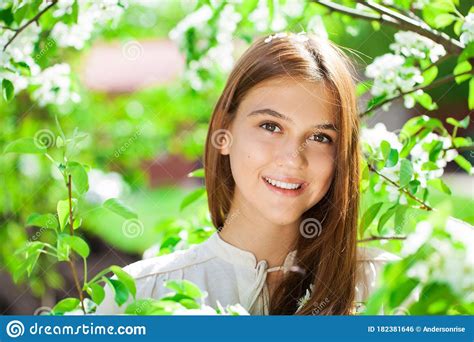 Pretty Teen Girl Are Posing In Garden Near Blossom Cherry