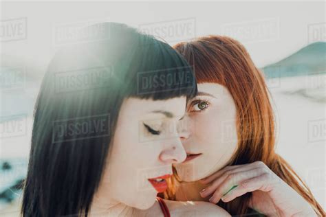Side View Of Modern Sensual Lesbian Couple In Love Embracing While