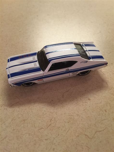white  blue toy car sitting  top   table