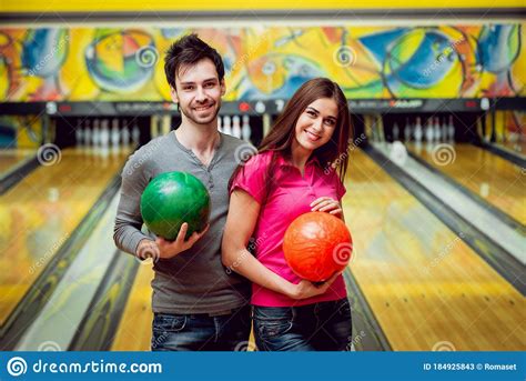 Cheerful Friends At The Bowling Alley With The Balls Stock Image