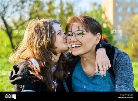 Happy Mother And Preteen Daughter Together Girl Hugging And Kissing