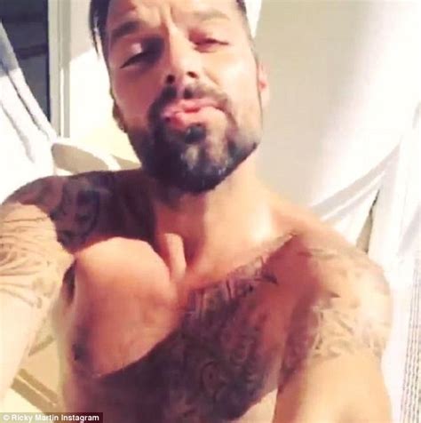 shirtless ricky martin flexes his muscles while living la