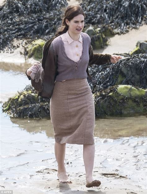 lily james pulls up stockings on guernsey set daily mail online
