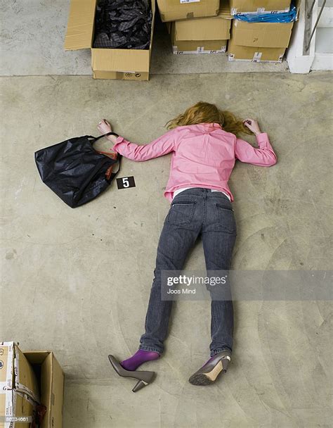 woman lying face down on storeroom floor murdered bildbanksbilder