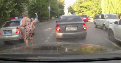 russian woman hit by police car on call as she crosses the road walks