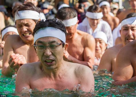 japanese men hug giant blocks of ice in freezing pool in bid to cleanse