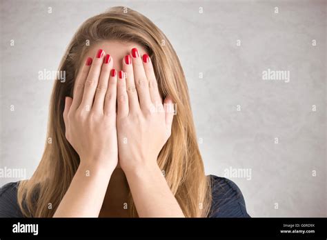 shy girl covering   face   hands isolated stock photo alamy