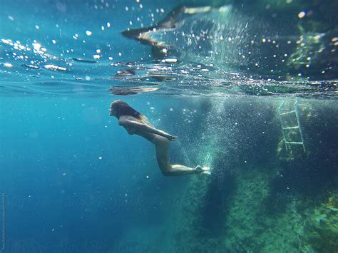 Skinny Girl Swimming Underwater In Clean Blue Sea By Sanja Lydia Kulusic