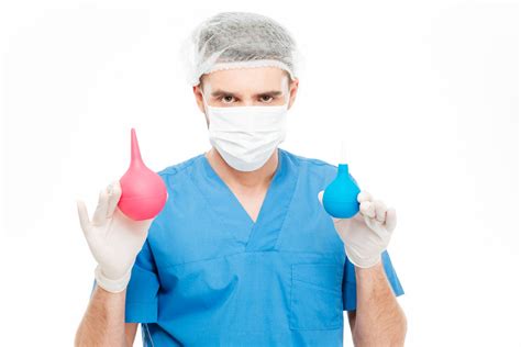 male surgeon holding medical enema isolated on a white background