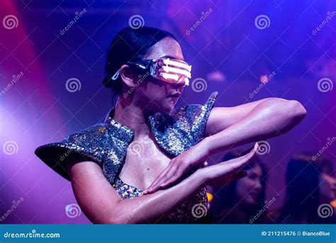 techno dancer in night club dancing to the beat of music from dj stock