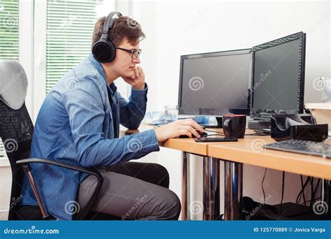 young man working  desktop computer stock image image  place