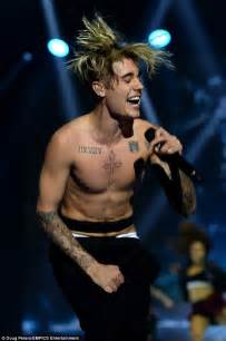 shirtless justin bieber shows off his tattooed torso at