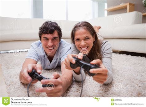 Couple Playing Video Games In The Living Room Stock Image