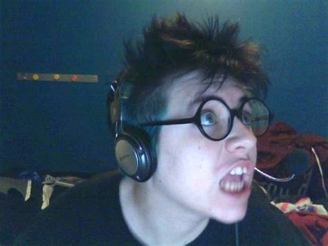 best nude girl person with messy hair wearing headphones and round glasses making a face at