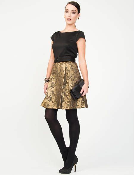 black dress with gold flared skirt black stockings and black pumps fashion dress heels dresses