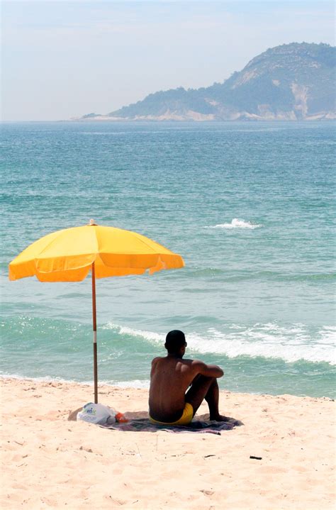 file man sitting under beach umbrella wikipedia the free