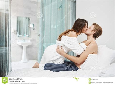 two beautiful people in love kissing and lying in hotel
