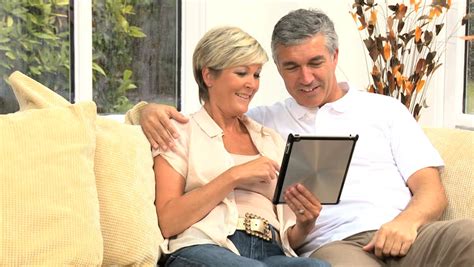 Attractive Mature Couple Using Modern Wireless Tablet For
