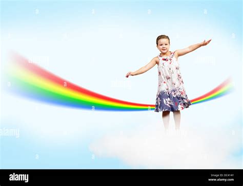 girl jumping  clouds   rainbow stock photo alamy